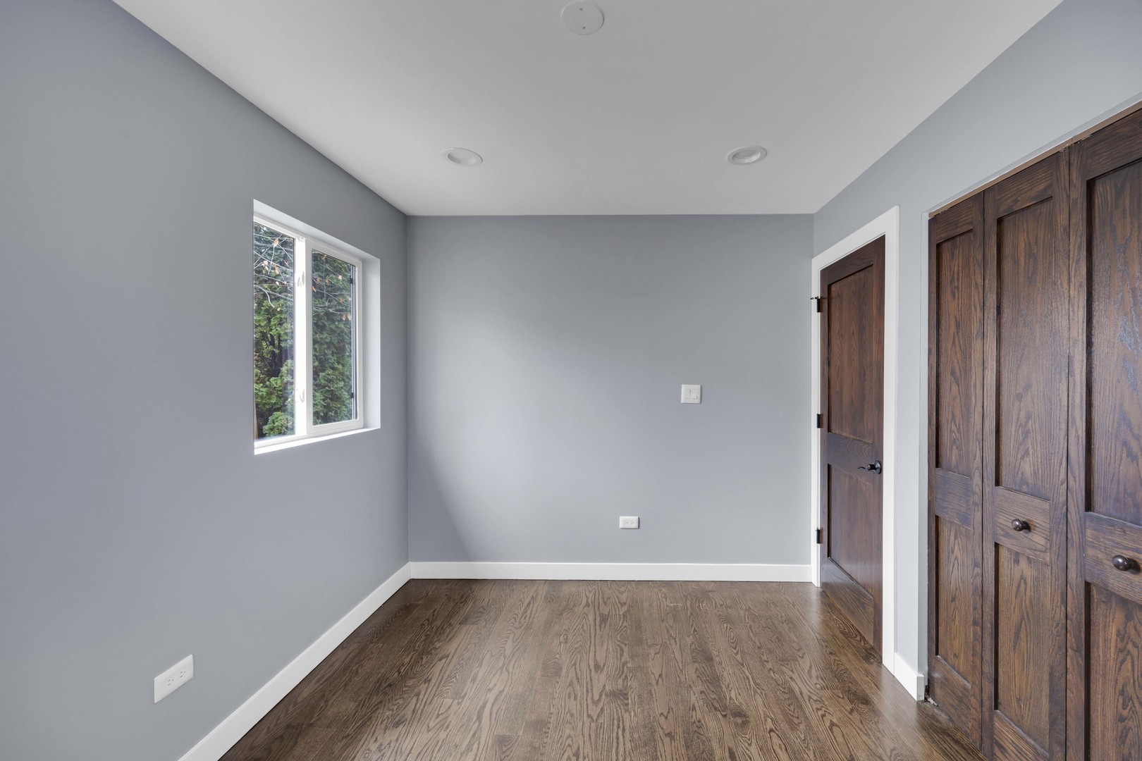 9059 Oneill Drive Burr Ridge, IL 60527 - Photo 9 of 15 a view of an empty room with wooden floor and a window