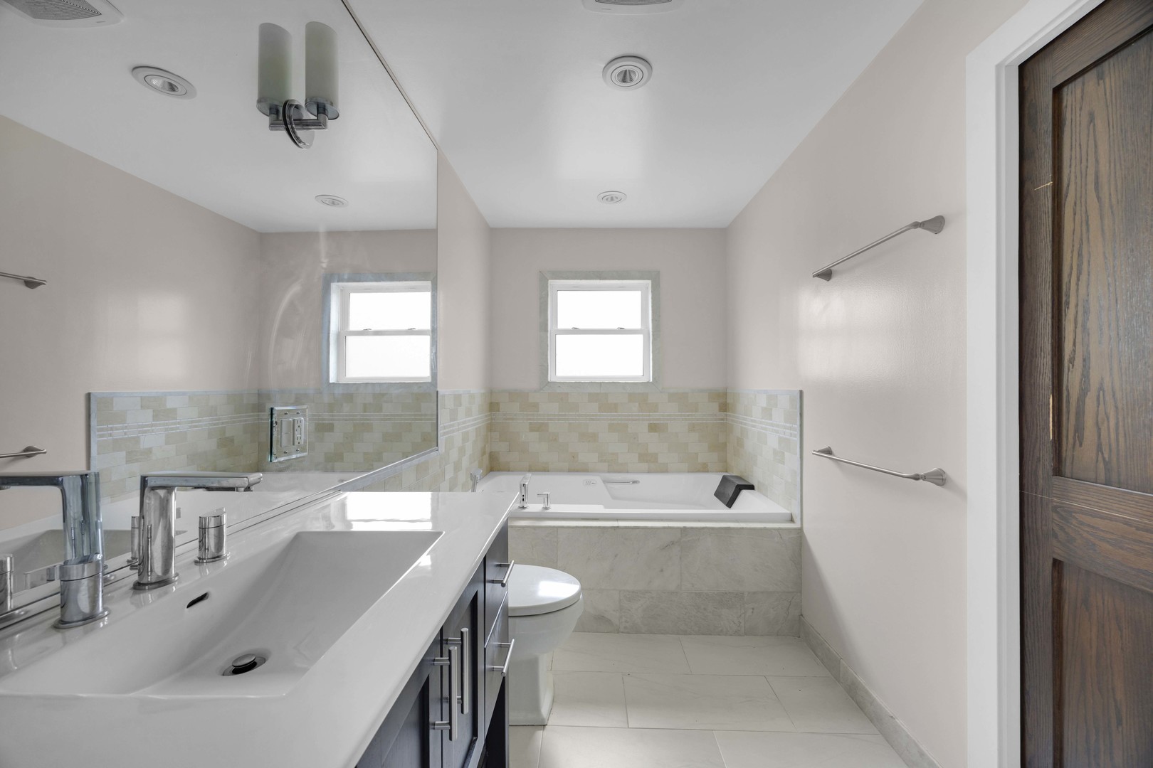 9059 Oneill Drive Burr Ridge, IL 60527 - Photo 10 of 15 a bathroom with a bathtub shower sink and mirror