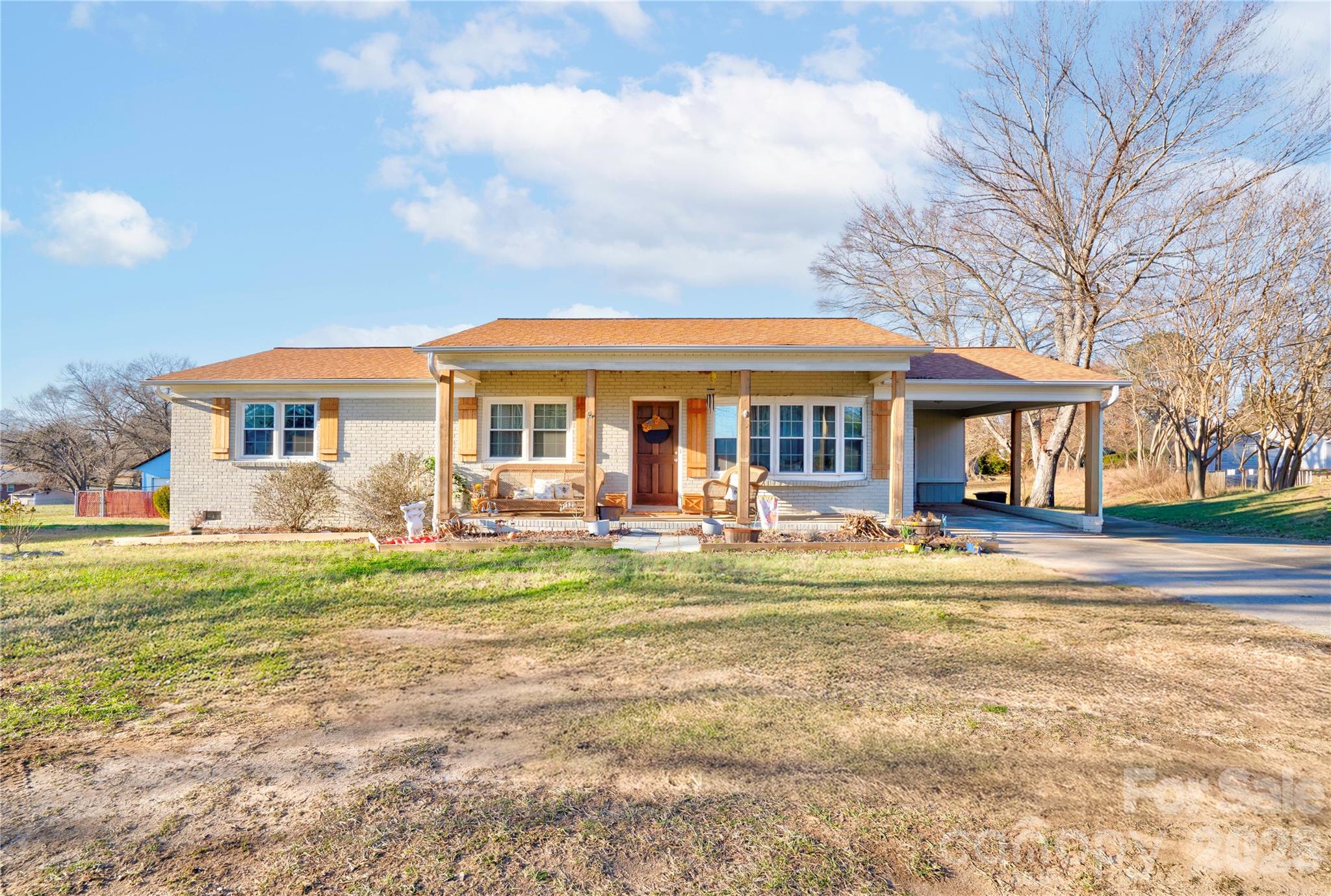 a front view of a house with swimming pool having outdoor seating