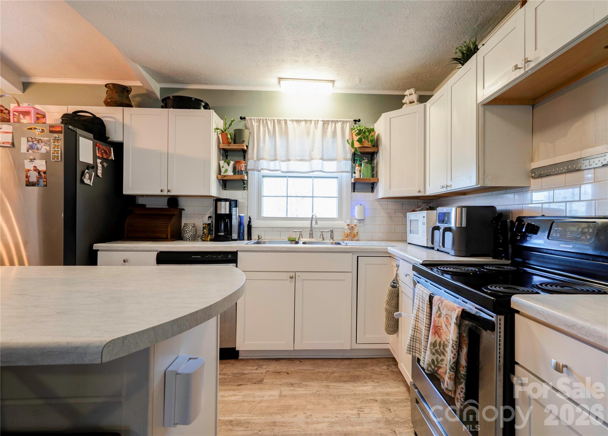 2106 South Post Road Shelby, NC 28152 - Photo 12 of 26 a kitchen with a sink a stove and cabinets