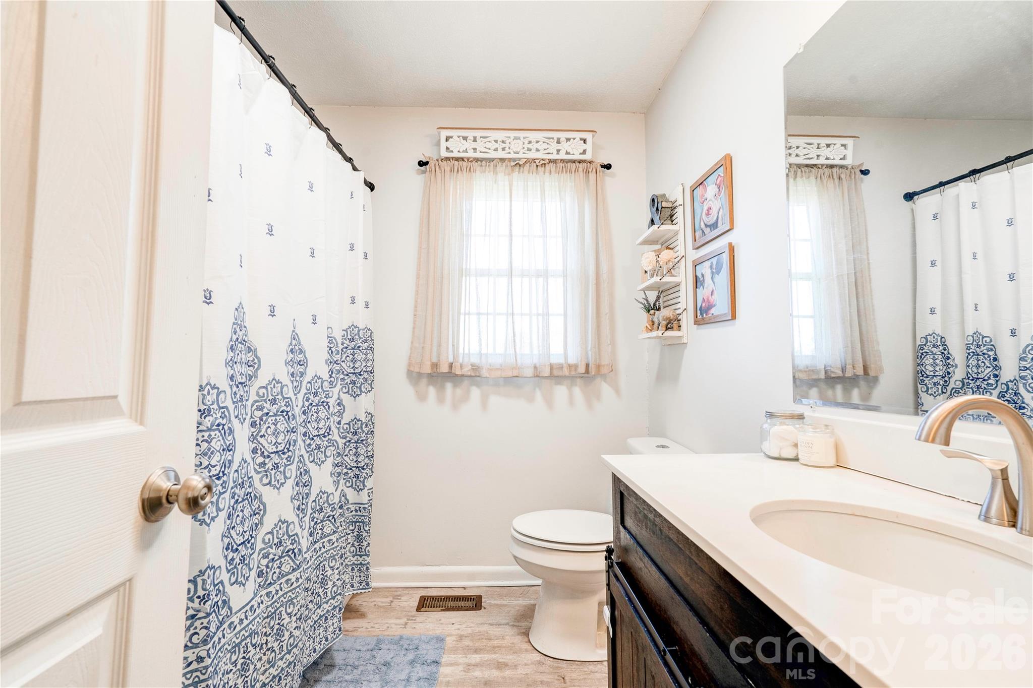 2106 South Post Road Shelby, NC 28152 - Photo 17 of 26 a bathroom with a granite countertop sink toilet and shower