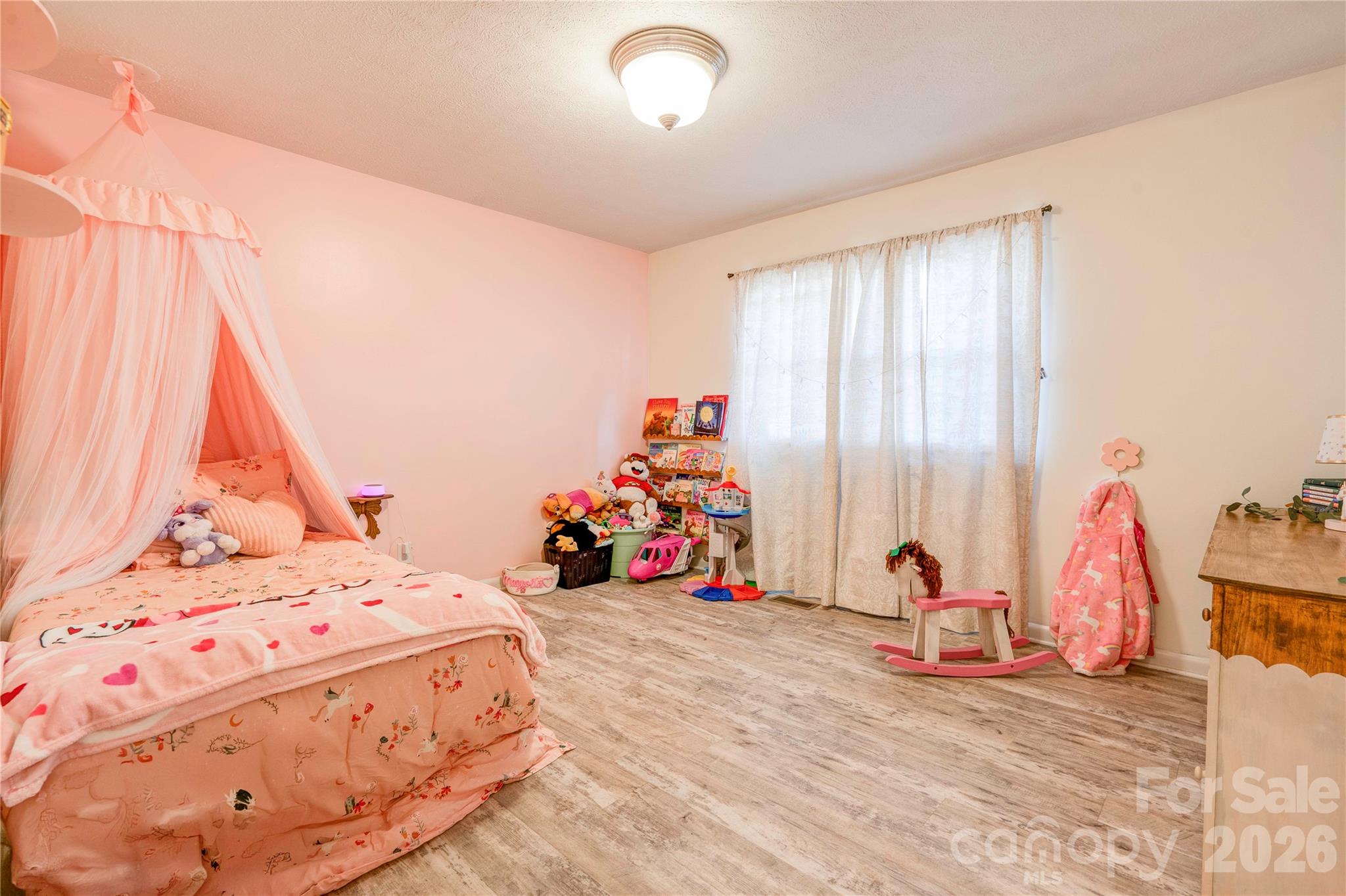 2106 South Post Road Shelby, NC 28152 - Photo 18 of 26 a view of a bedroom with a bed and a chandelier