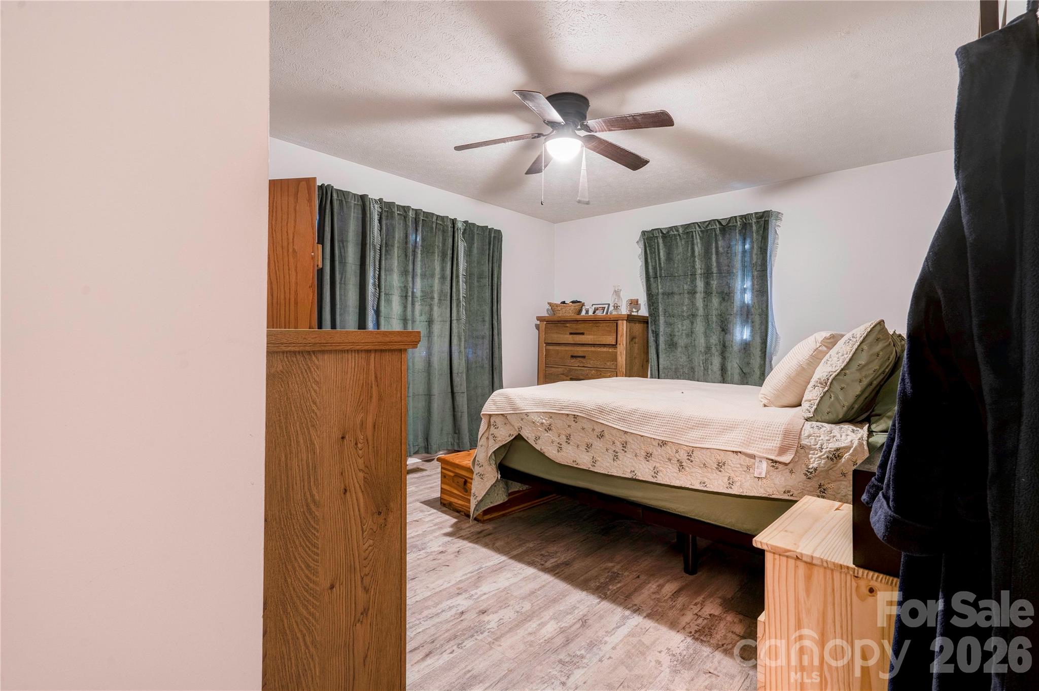 2106 South Post Road Shelby, NC 28152 - Photo 21 of 26 a spacious bedroom with a bed and a chandelier