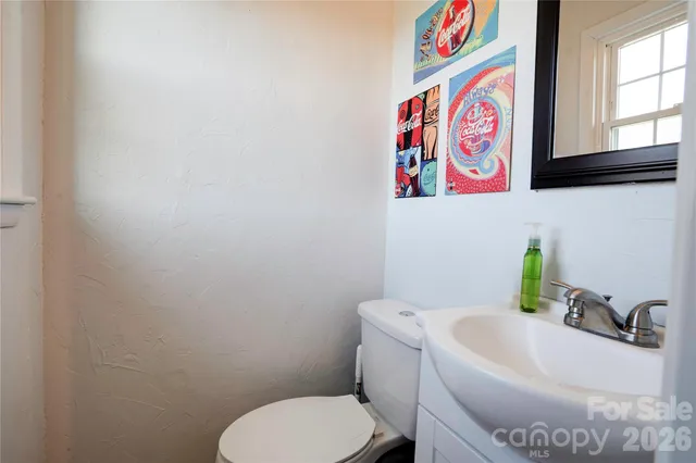 a white toilet sitting next to a bathroom sink