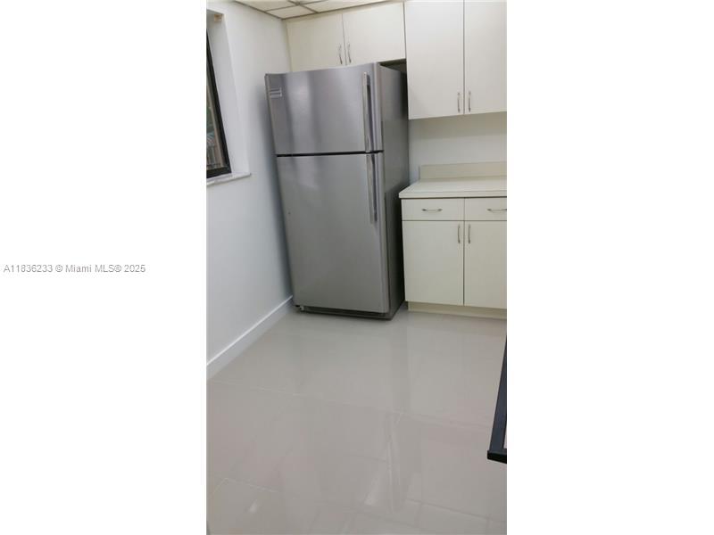 8015 Southwest 107th Avenue, Unit 209 Miami, FL 33173 - Photo 21 of 43 a view of a room with a refrigerator
