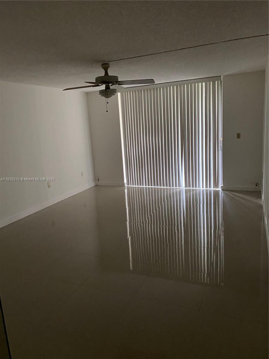 8015 Southwest 107th Avenue, Unit 209 Miami, FL 33173 - Photo 24 of 43 an empty room with wooden floor and windows