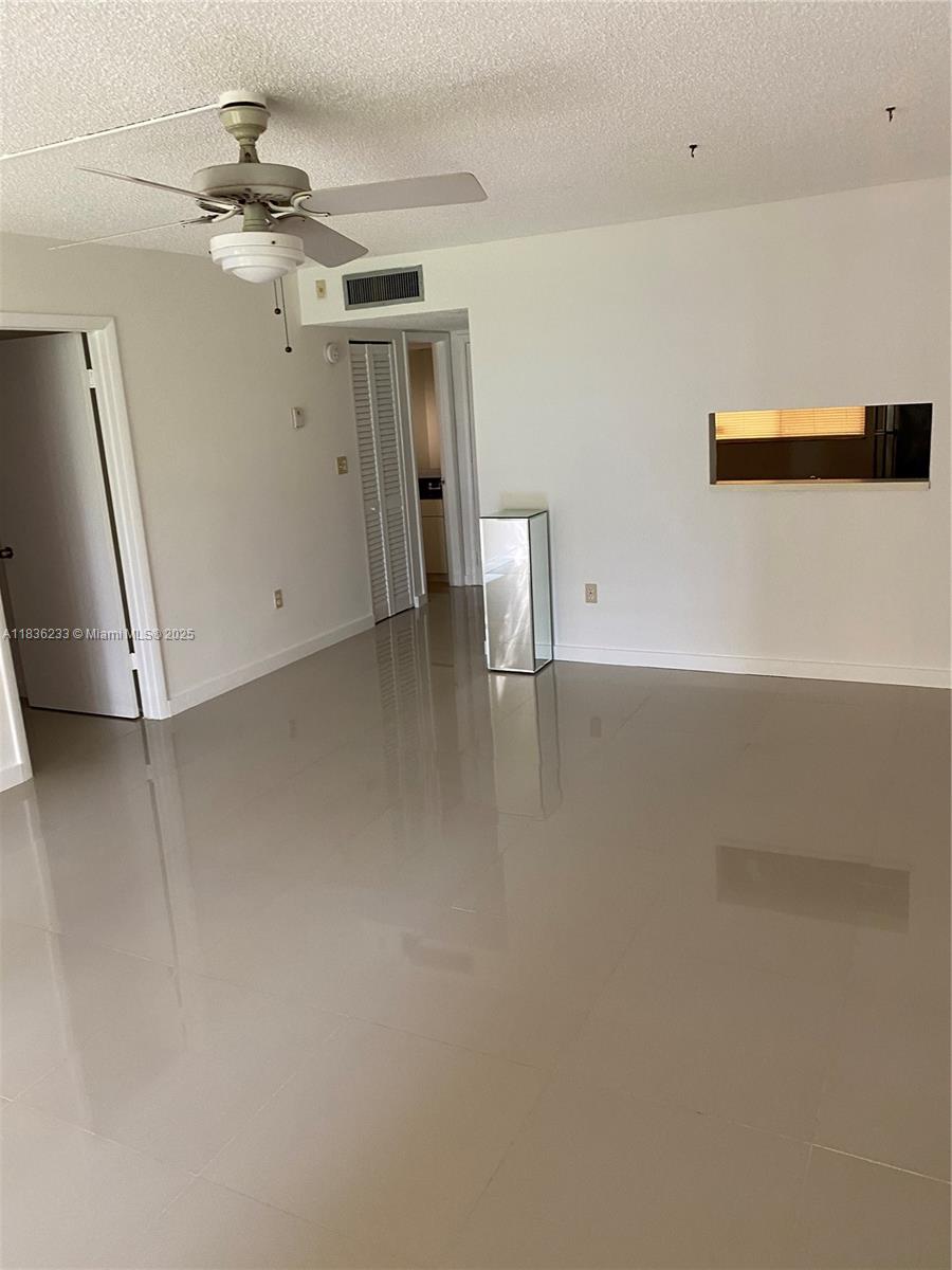 8015 Southwest 107th Avenue, Unit 209 Miami, FL 33173 - Photo 27 of 43 wooden floor in an empty room with a window