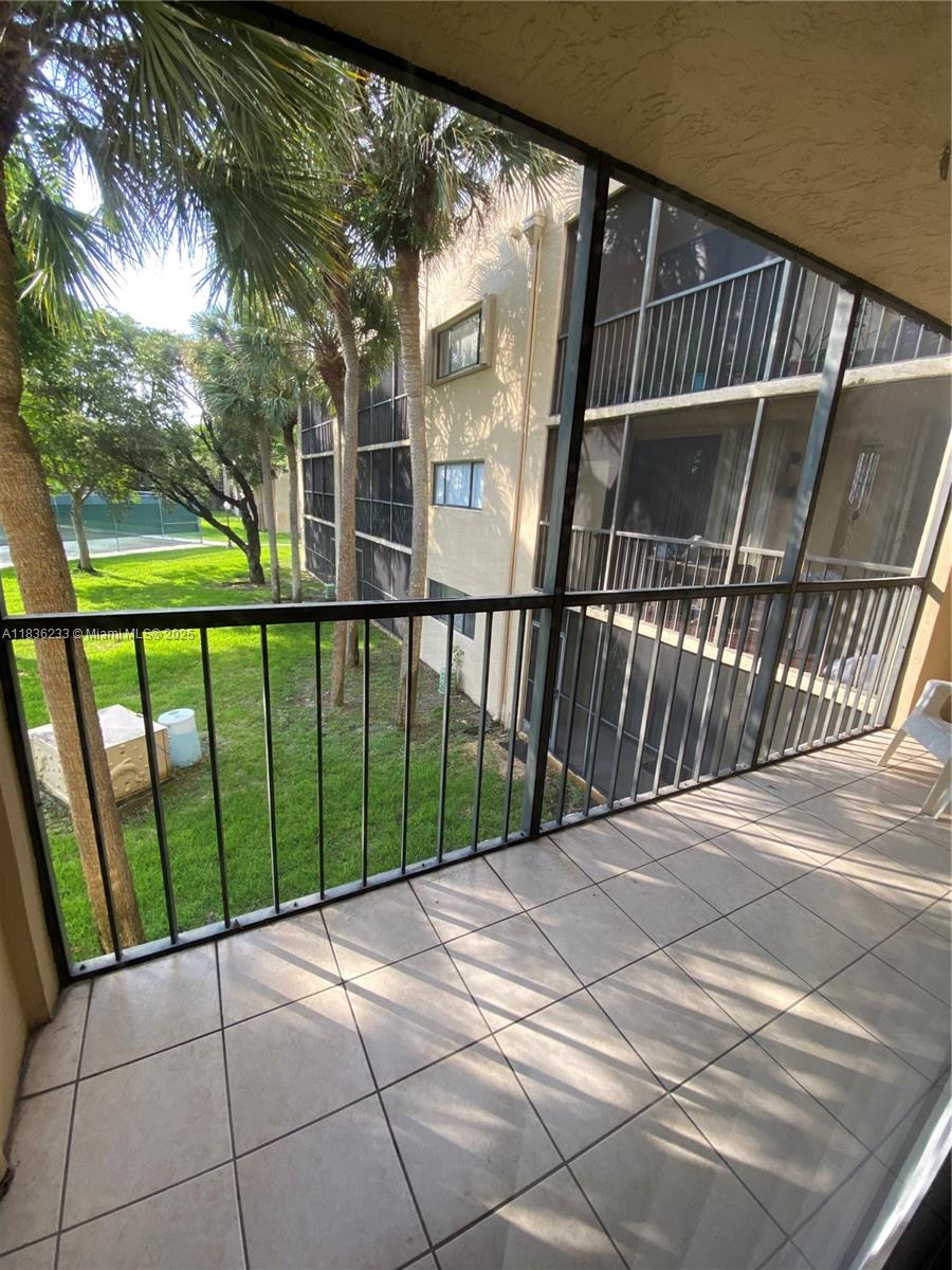 8015 Southwest 107th Avenue, Unit 209 Miami, FL 33173 - Photo 40 of 43 a view of balcony with wooden floor