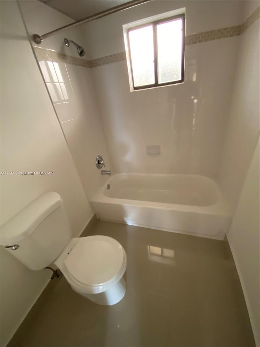 8015 Southwest 107th Avenue, Unit 209 Miami, FL 33173 - Photo 9 of 43 a bathroom with a toilet and a shower
