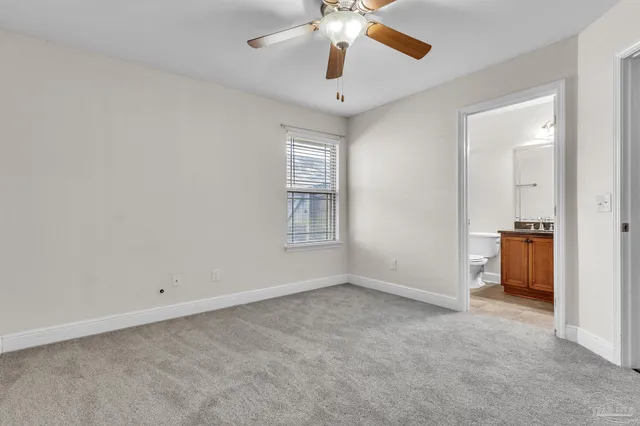 an empty room and chandelier fan