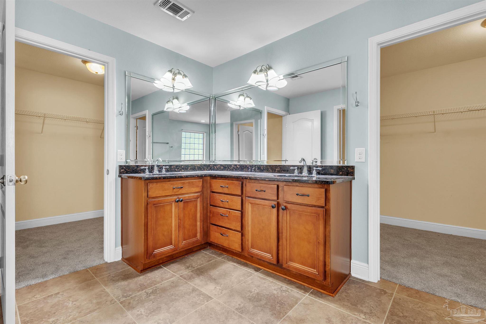 6129 Stonechase Boulevard Pace, FL 32571 - Photo 39 of 61 closet goes around the back of the vanities