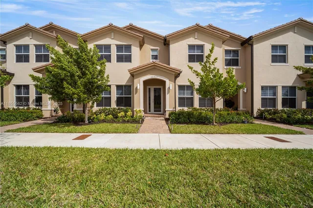 a front view of a house with a yard and garage