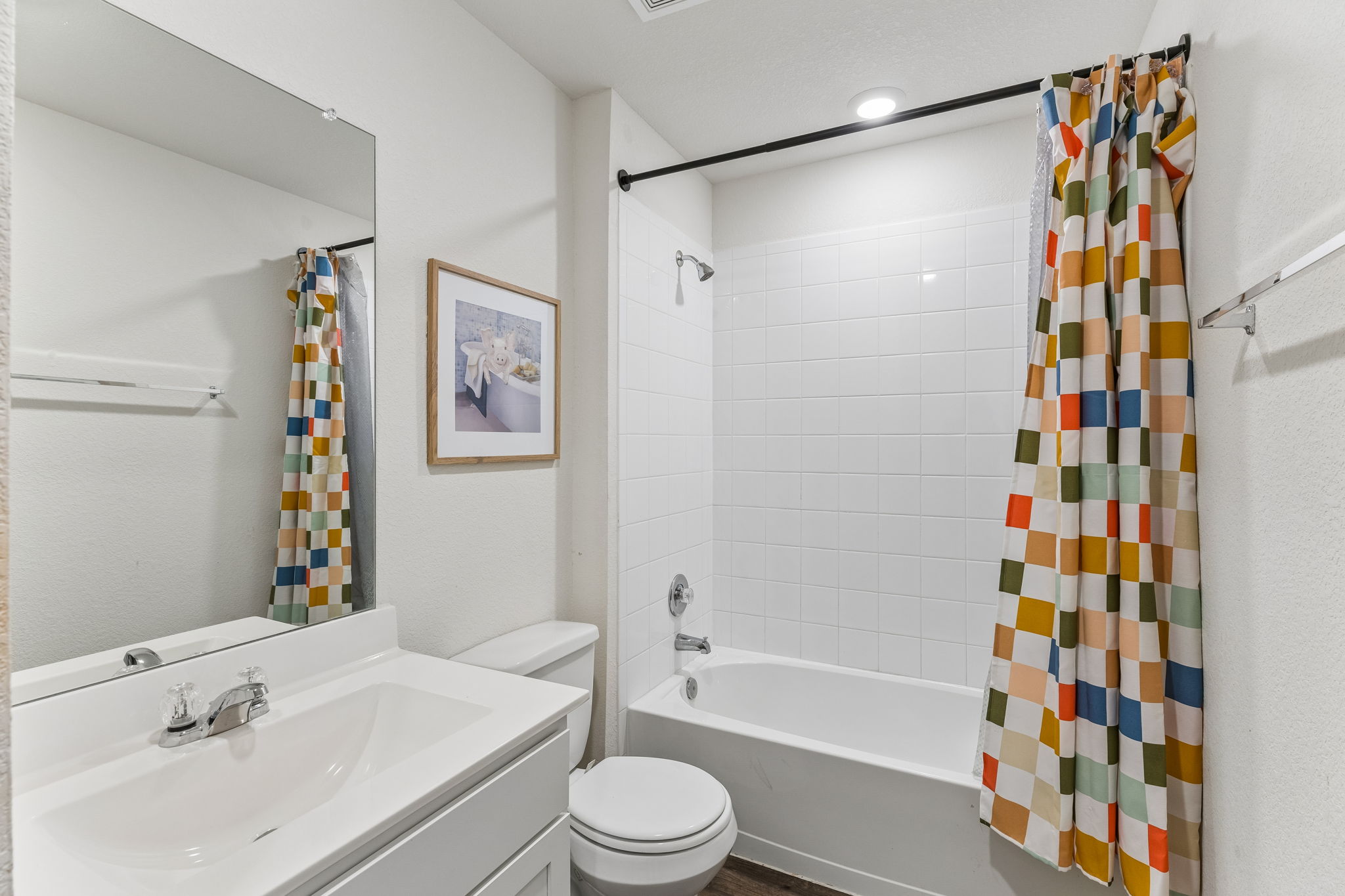 343 Sickle Loop Kyle, TX 78640 - Photo 33 of 40 Bathroom with a white vanity and integrated sink, a large wall-mounted mirror, and a toilet