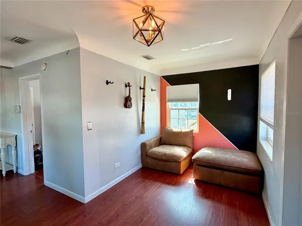 a living room with furniture and wooden floor