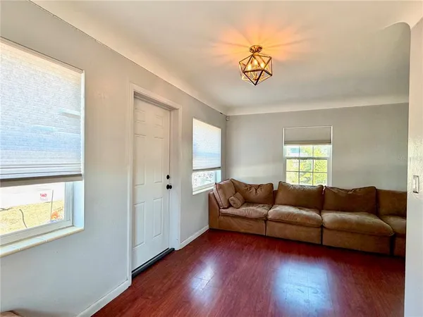 a living room with furniture and a hard wood floor