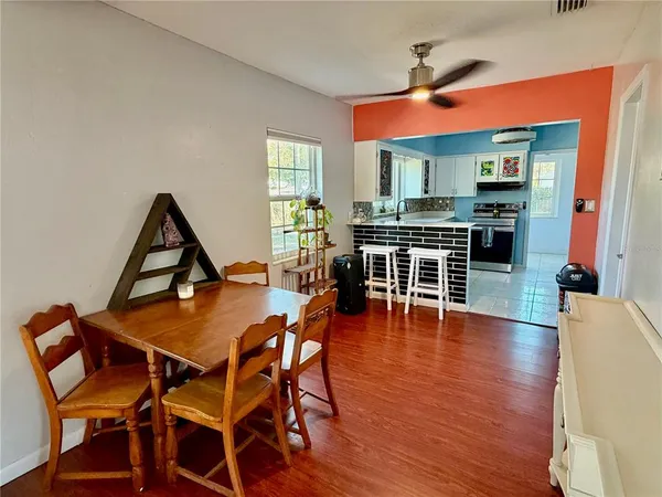 a dining room with a wooden table and chairs