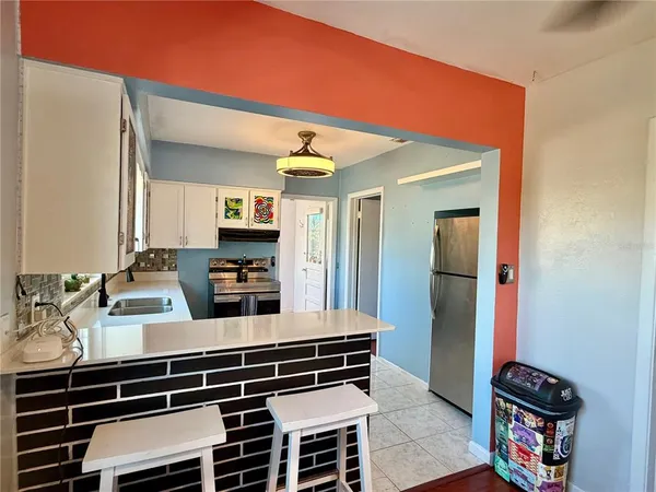 a kitchen with stainless steel appliances a stove and a refrigerator