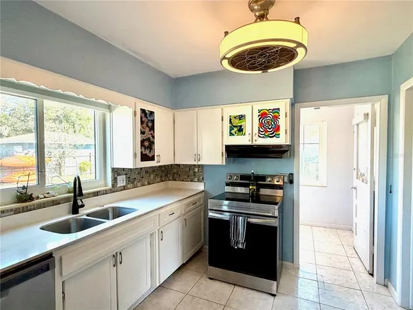 a kitchen with a sink and a stove