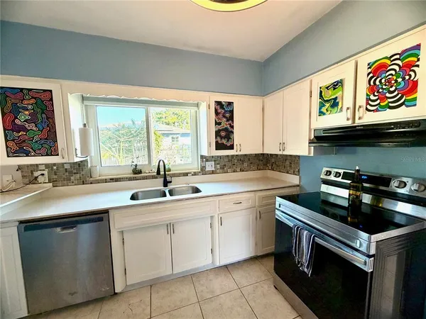 a kitchen that has a sink and a stove