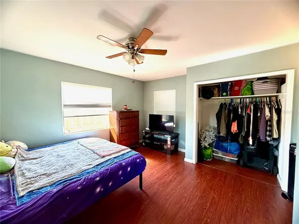 a bedroom with a bed and wooden floor