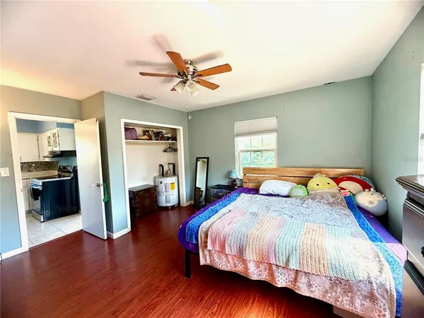 a bedroom with a bed and a view of kitchen