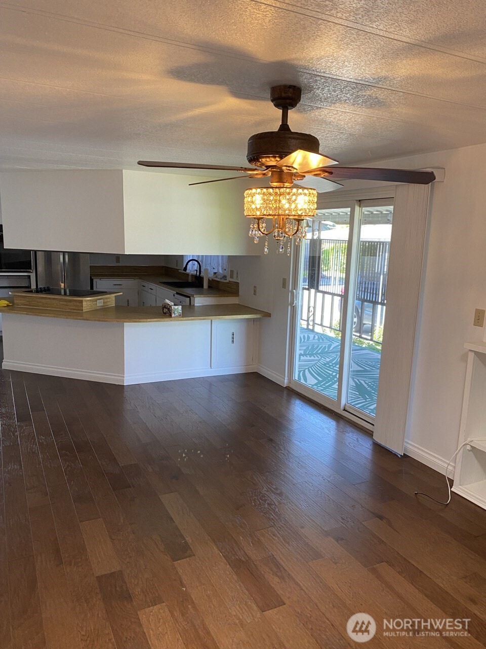 1402 22nd Street Northeast, Unit 252 Auburn, WA 98002 - Photo 12 of 36 a kitchen with stainless steel appliances granite countertop a stove a sink dishwasher a refrigerator and wooden floor