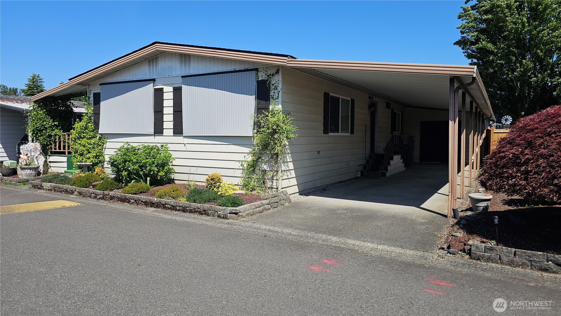 1402 22nd Street Northeast, Unit 252 Auburn, WA 98002 - Photo 2 of 36 a front view of a house with a yard and garage