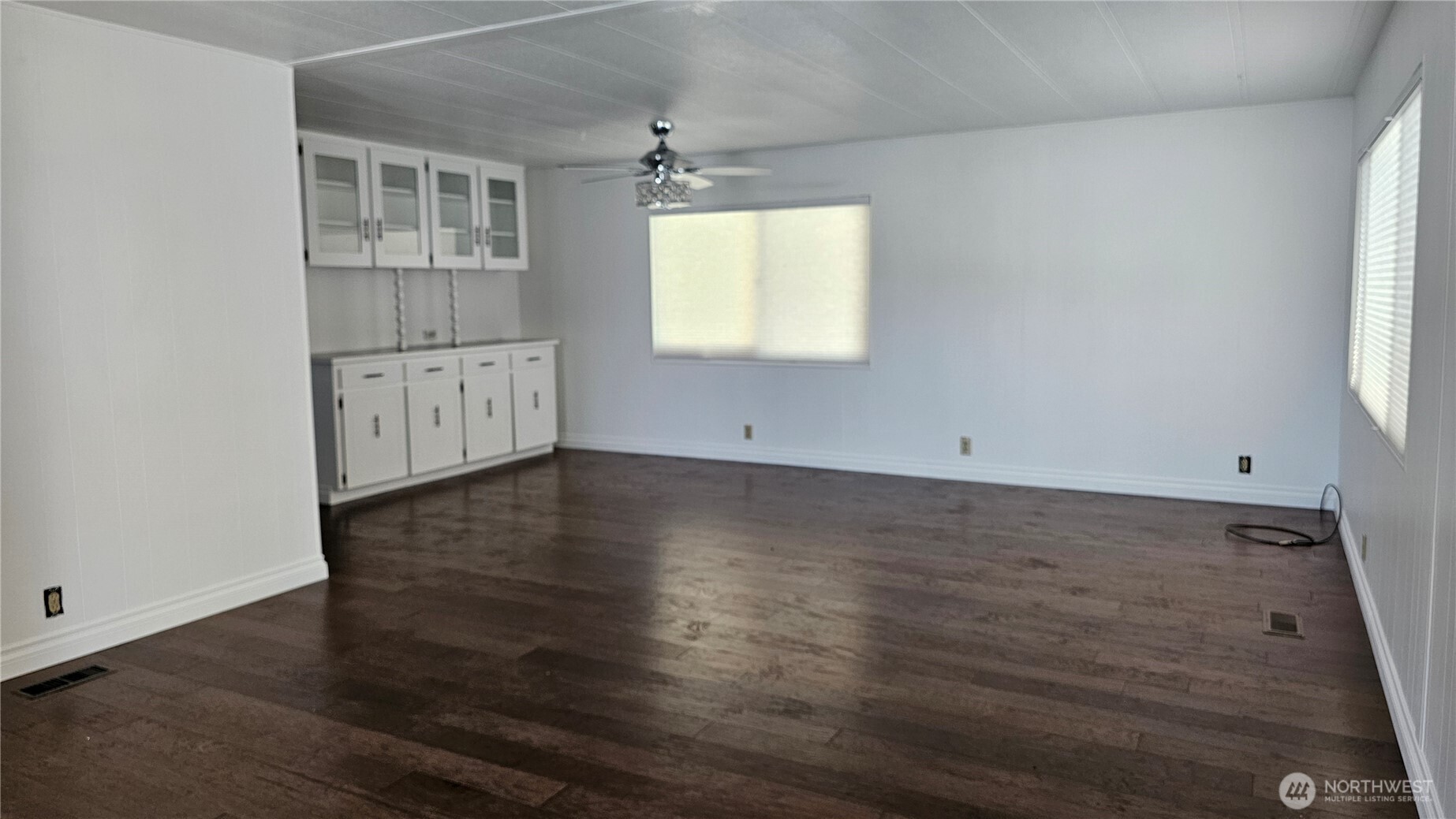 1402 22nd Street Northeast, Unit 252 Auburn, WA 98002 - Photo 23 of 36 an empty room with wooden floor and windows