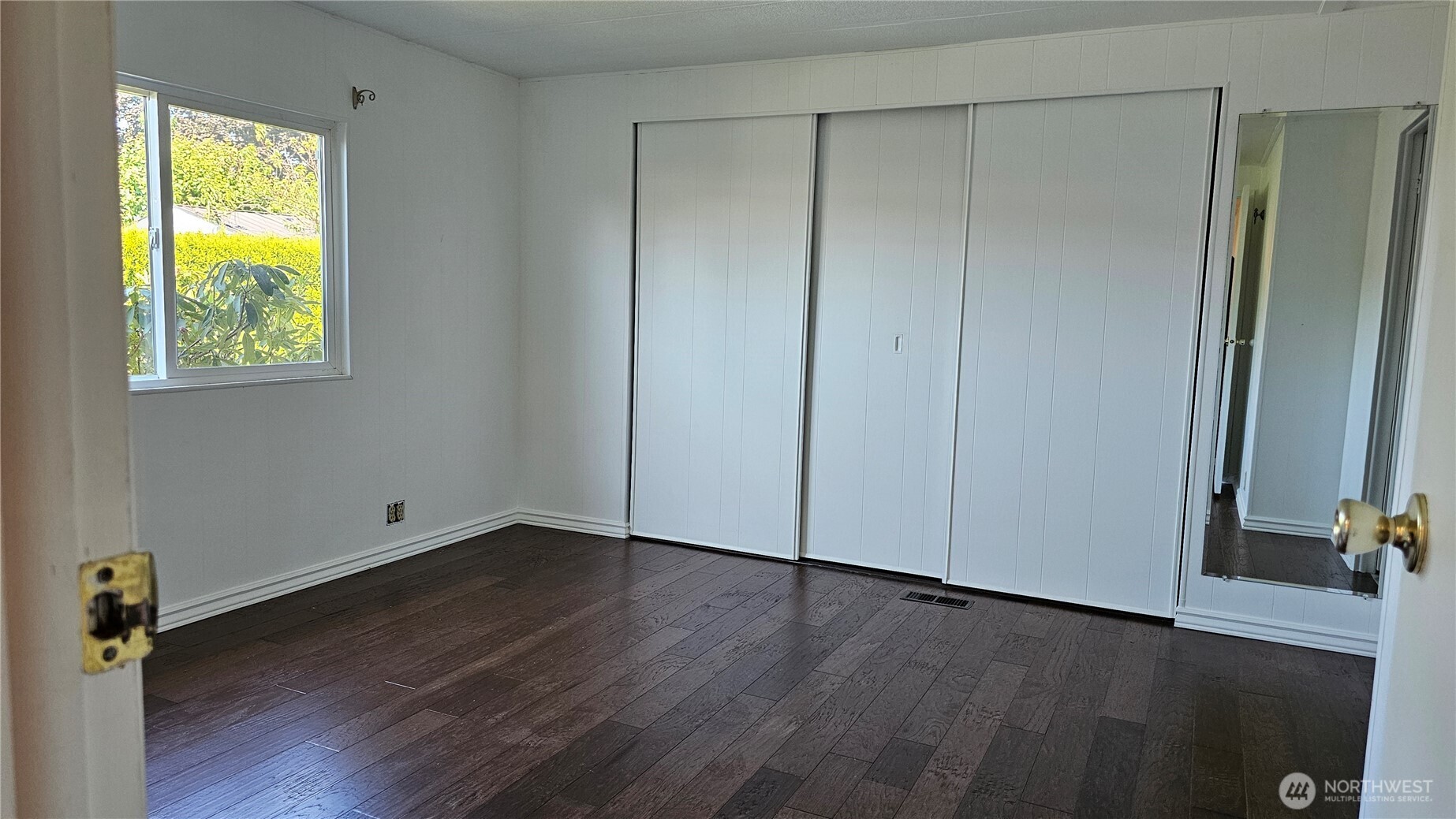 1402 22nd Street Northeast, Unit 252 Auburn, WA 98002 - Photo 24 of 36 a view of an empty room with wooden floor and a window