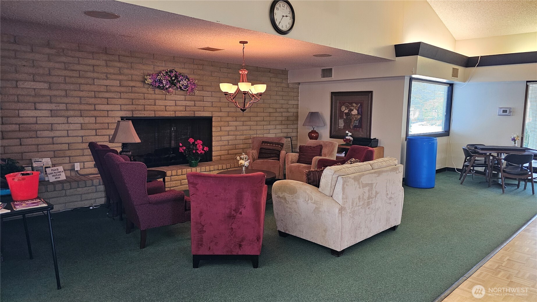 1402 22nd Street Northeast, Unit 252 Auburn, WA 98002 - Photo 31 of 36 a living room with furniture a fireplace and a flat screen tv