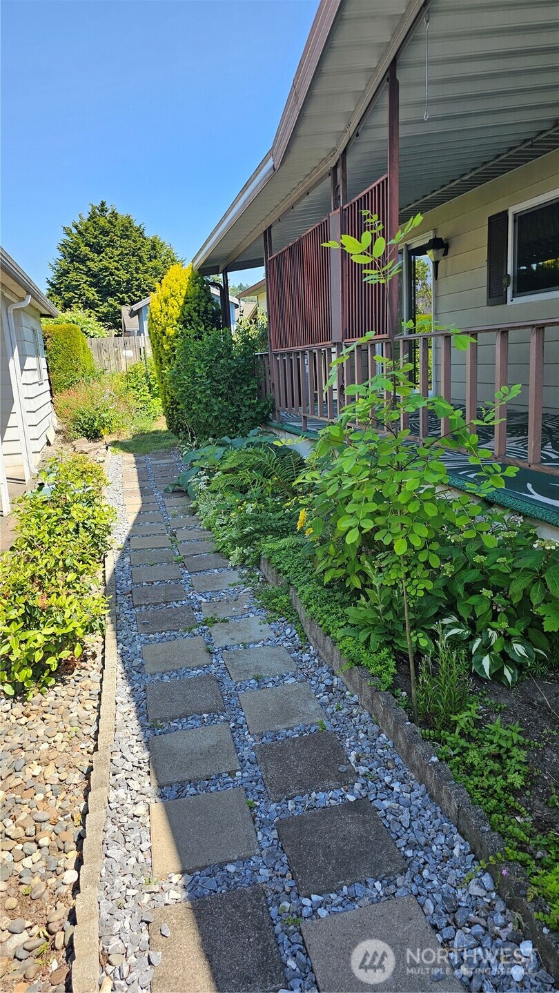 1402 22nd Street Northeast, Unit 252 Auburn, WA 98002 - Photo 4 of 36 a view of a house with a yard