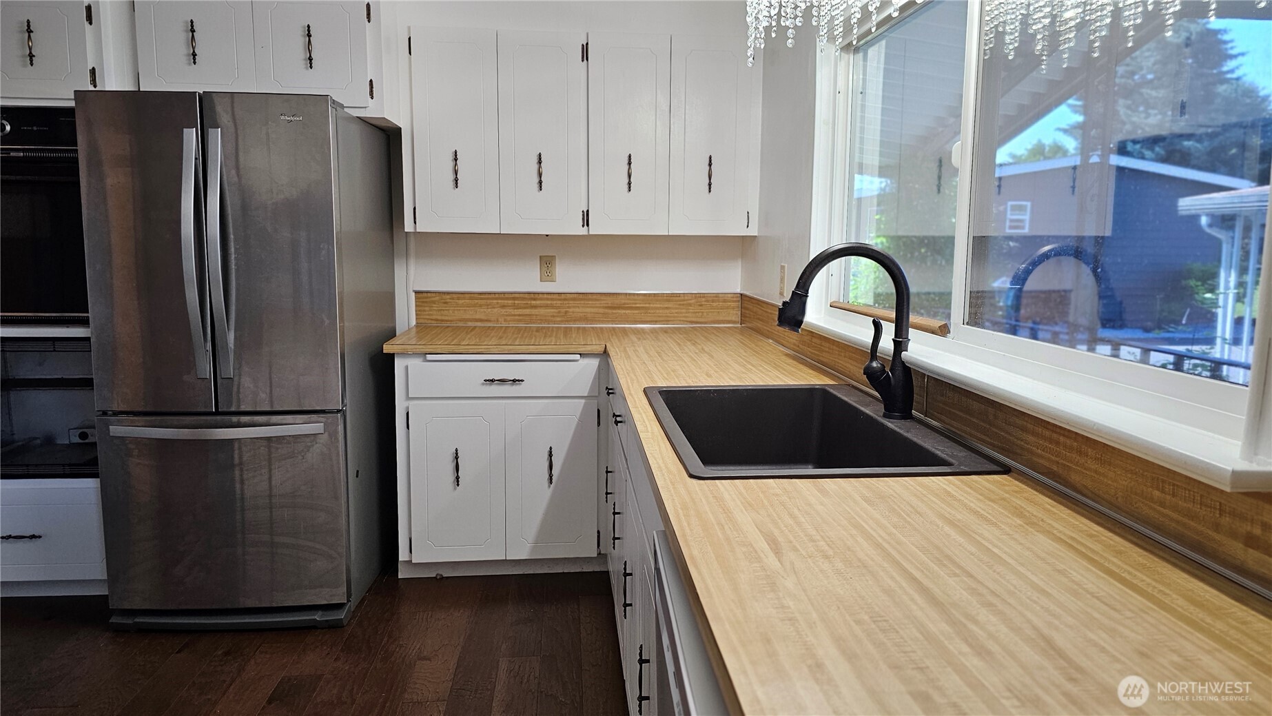 1402 22nd Street Northeast, Unit 252 Auburn, WA 98002 - Photo 7 of 36 a kitchen with a refrigerator sink and cabinets