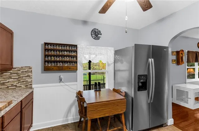 a kitchen with stainless steel appliances granite countertop a refrigerator and a stove top oven