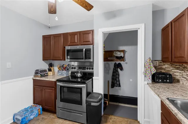 a kitchen with a sink stainless steel appliances and cabinets