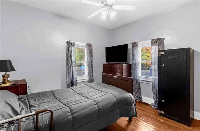 a bedroom with a bed and a television