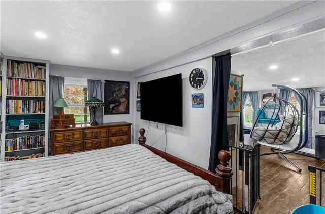 a bedroom with furniture and a flat screen tv