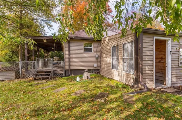 a backyard of a house with table and chairs