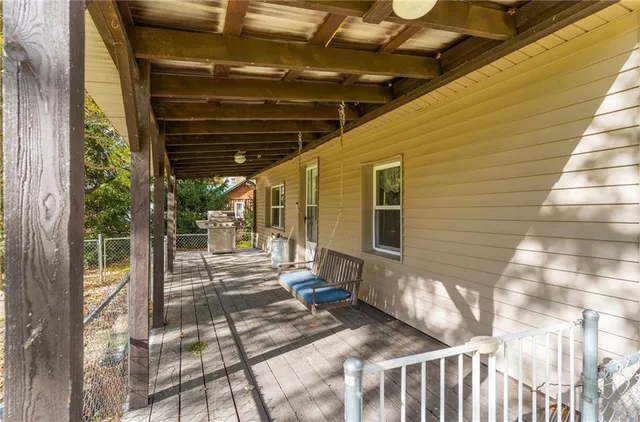 a view of a porch with wooden chairs