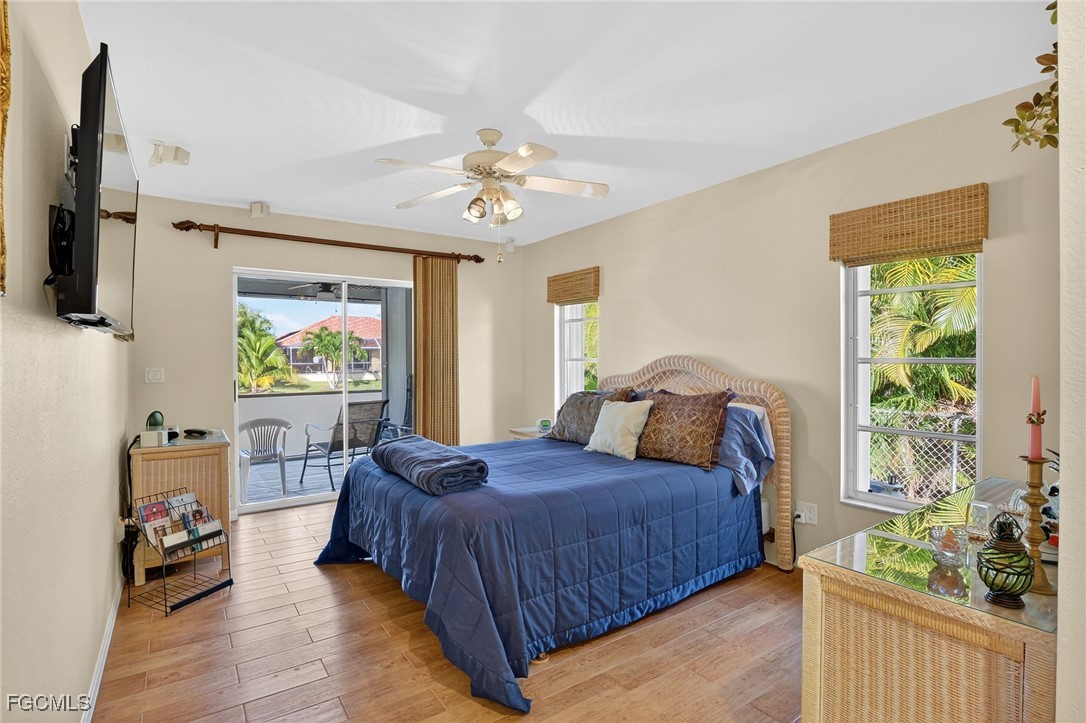 4306 Southwest 3rd Avenue Cape Coral, FL 33914 - Photo 21 of 50 a bedroom with a bed a flat screen tv and a window