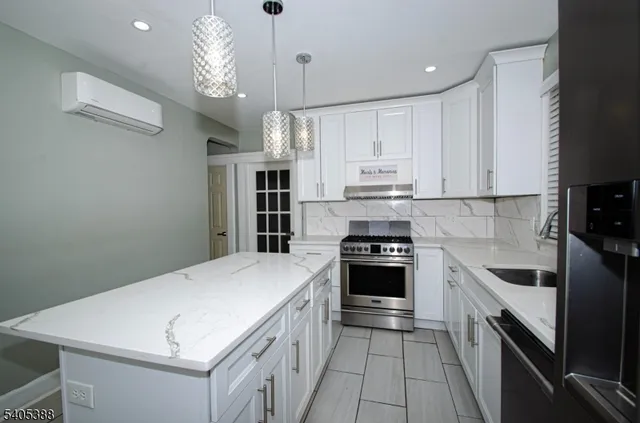 a kitchen with a stove a sink and a refrigerator