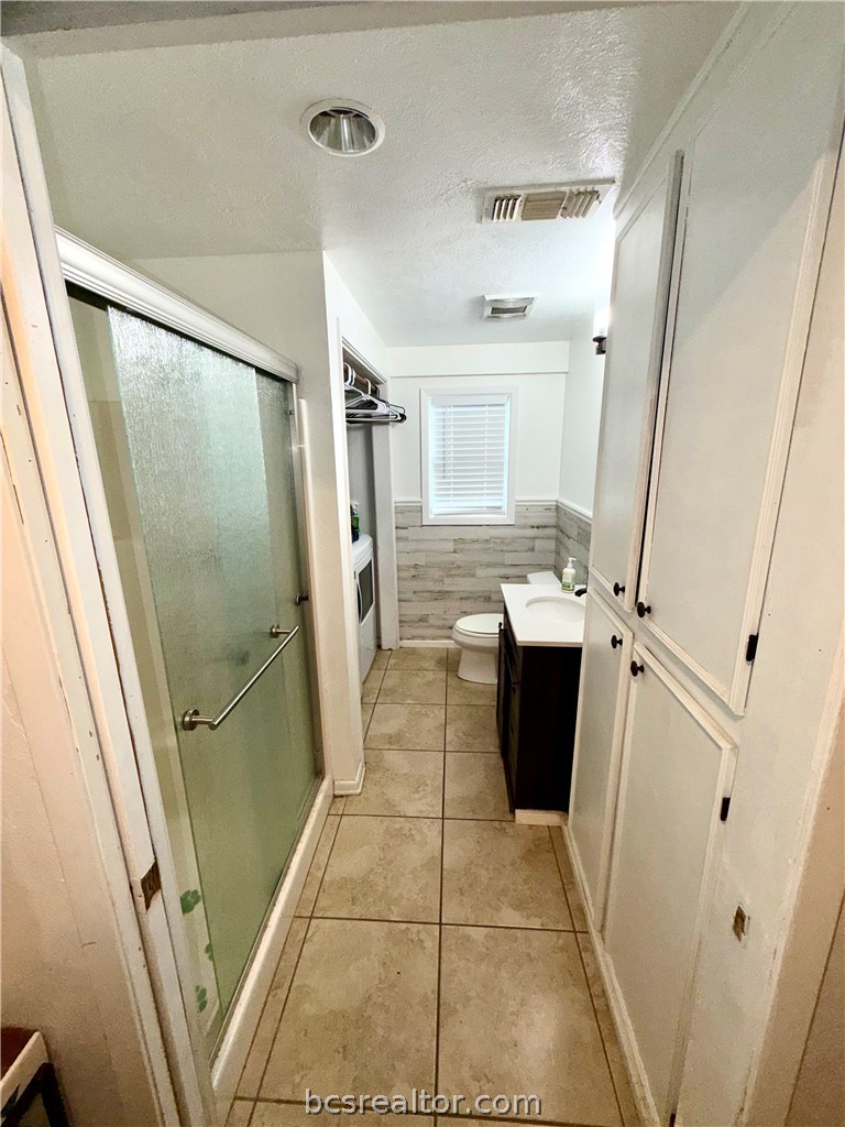 421 South Commerce Street Centerville, TX 75833 - Photo 15 of 23 a bathroom with a granite countertop shower and a sink