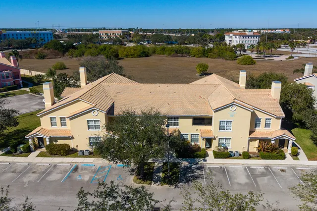 an aerial view of a house with a yard and lake view