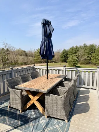 a roof deck with a table and chairs