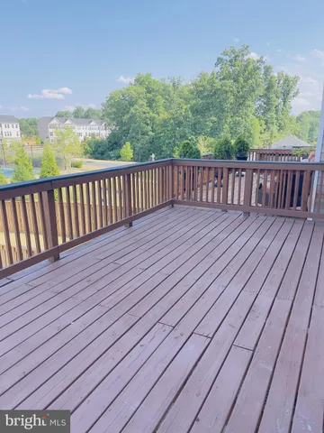 a balcony with wooden floor and fence