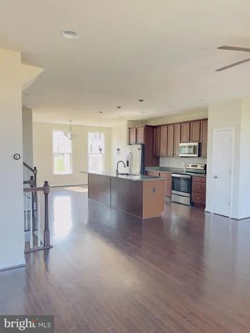 a view of a kitchen with a sink cabinets and wooden floor