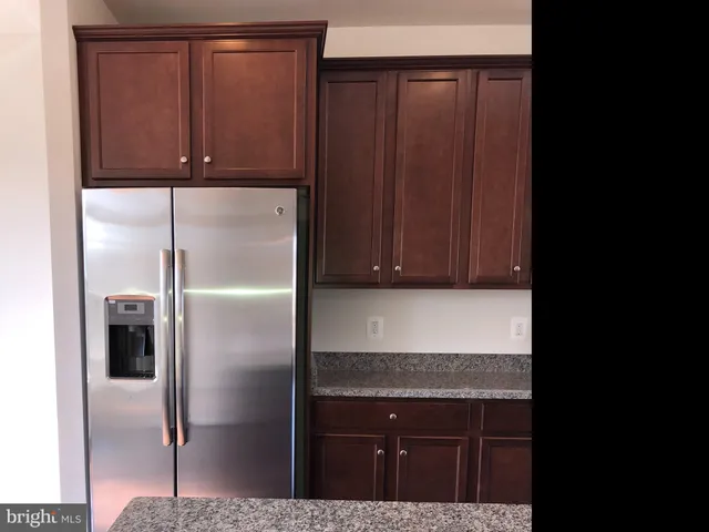a kitchen with a refrigerator and cabinets