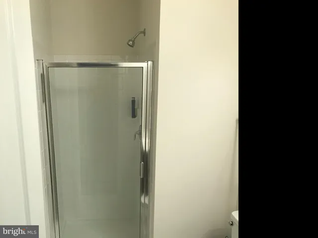 a picture of a bathroom with a shower and a sink