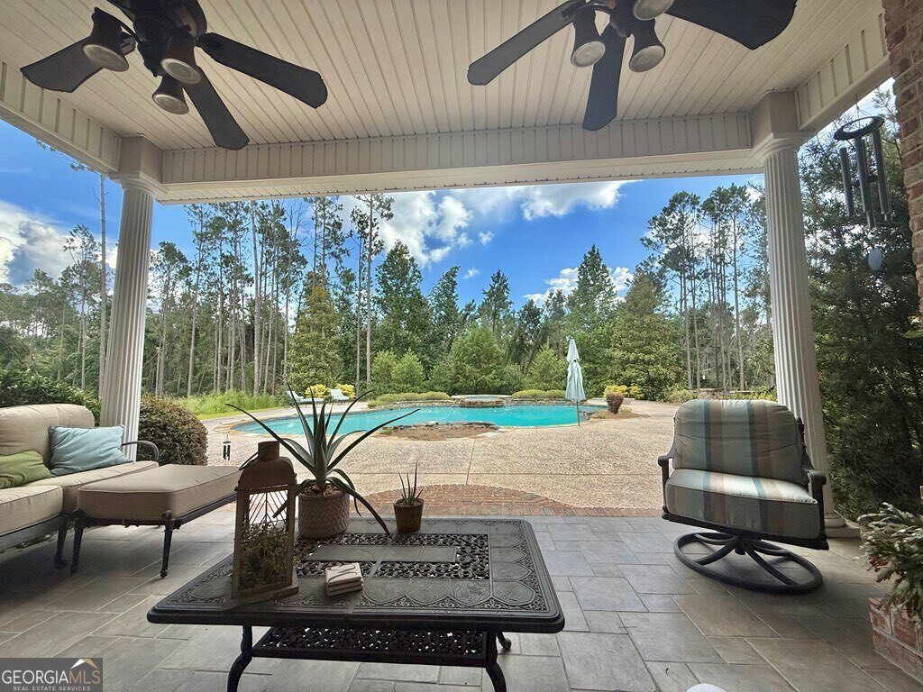 3 Chestnut Road Hazlehurst, GA 31539 - Photo 56 of 66 a living room with patio furniture and a floor to ceiling window