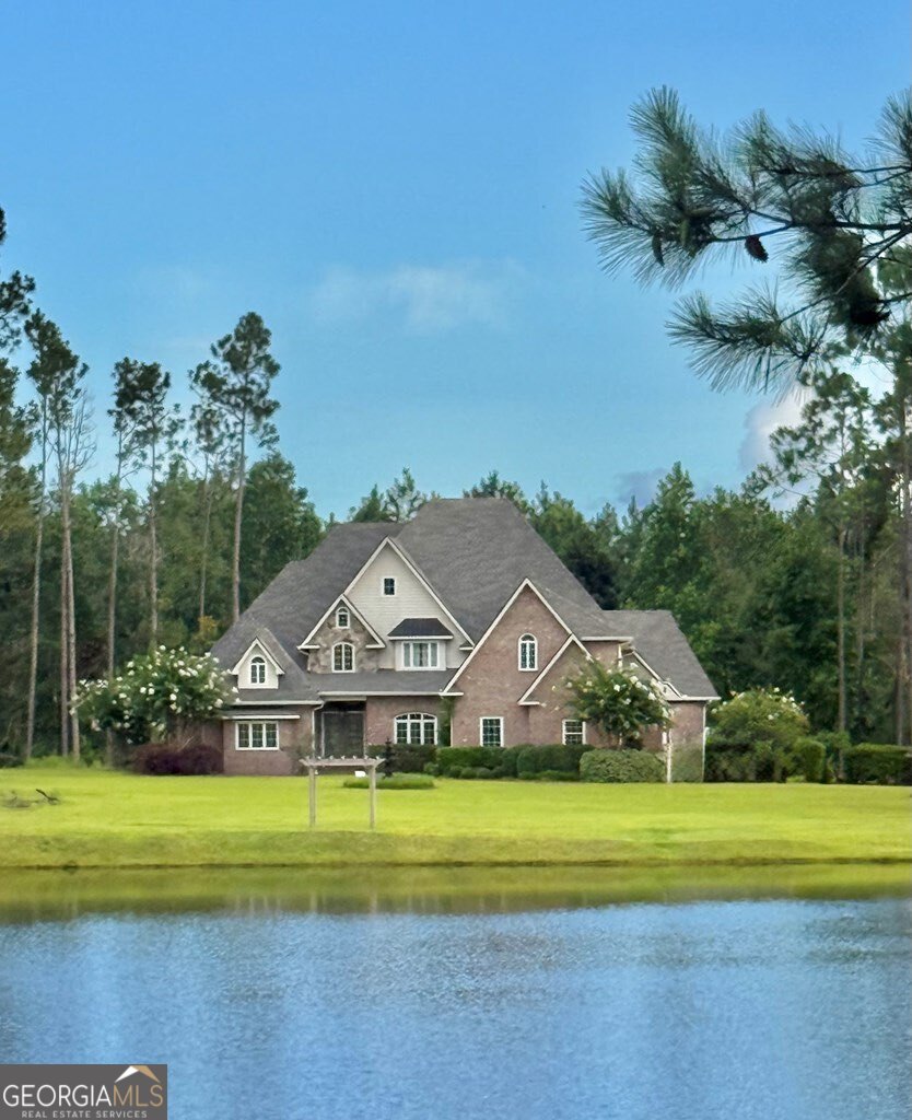 3 Chestnut Road Hazlehurst, GA 31539 - Photo 62 of 66 a view of a house with a big yard and potted plants