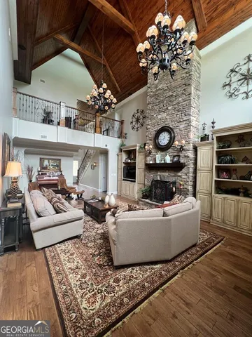 a view of a dining room with furniture wooden floor and chandelier
